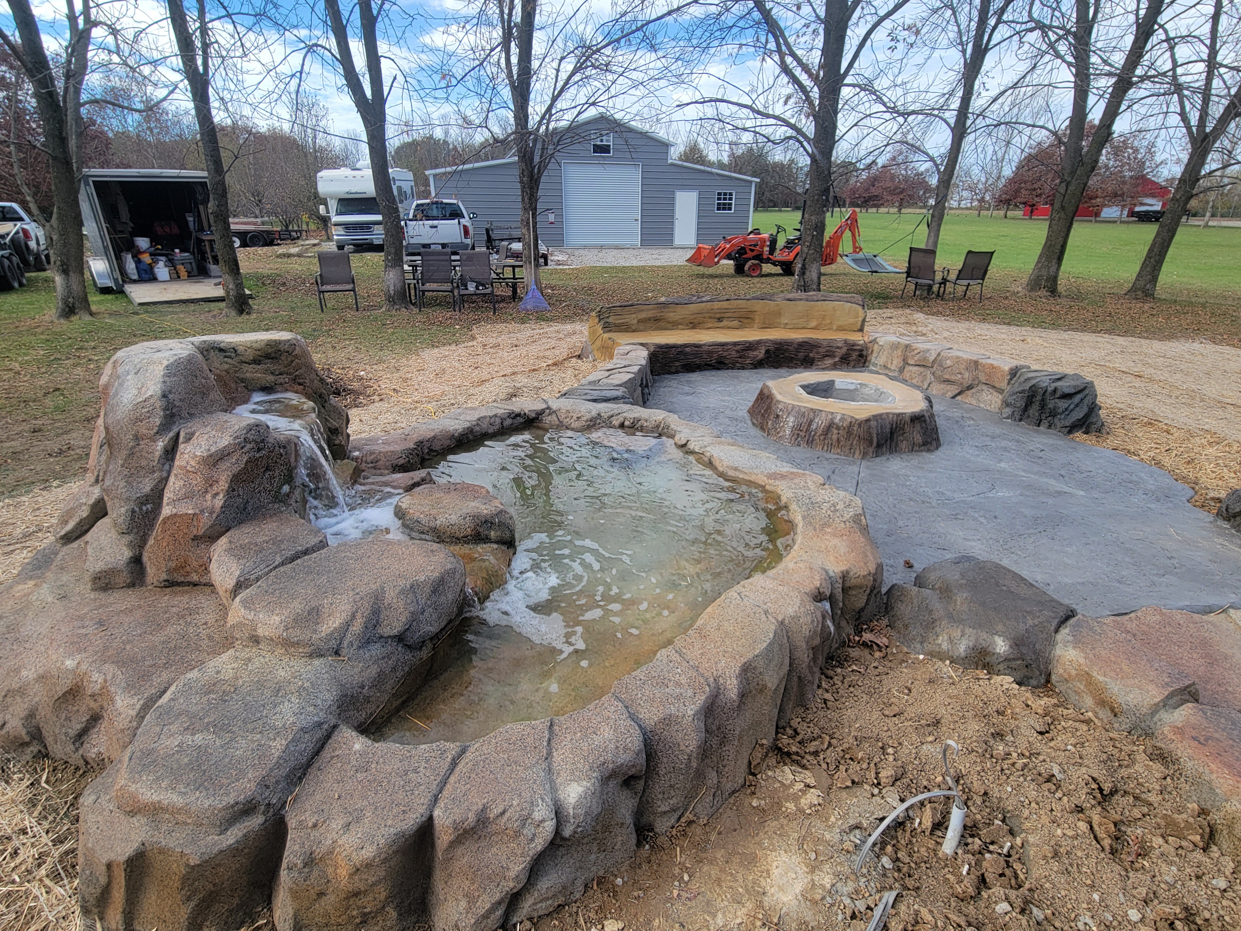 Water feature, fire pit, and patio