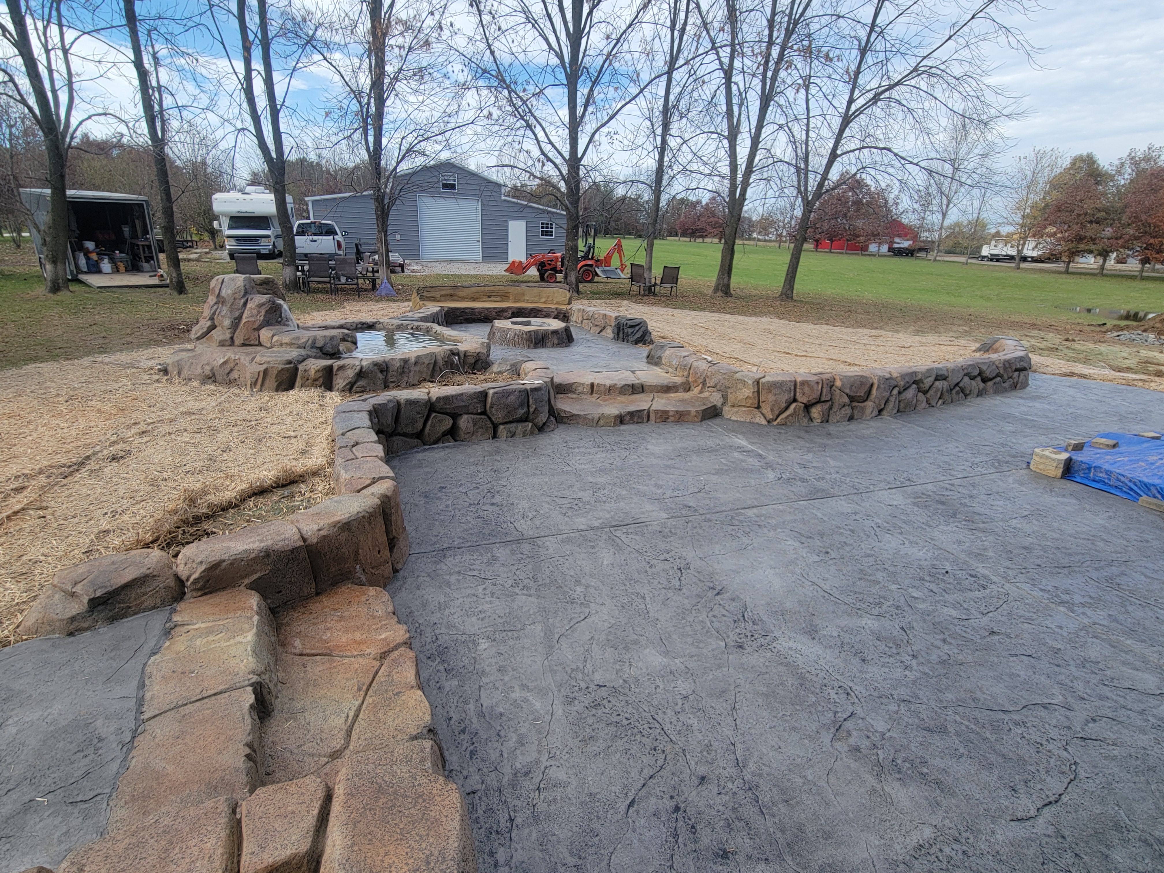 Water feature, fire pit, and patio