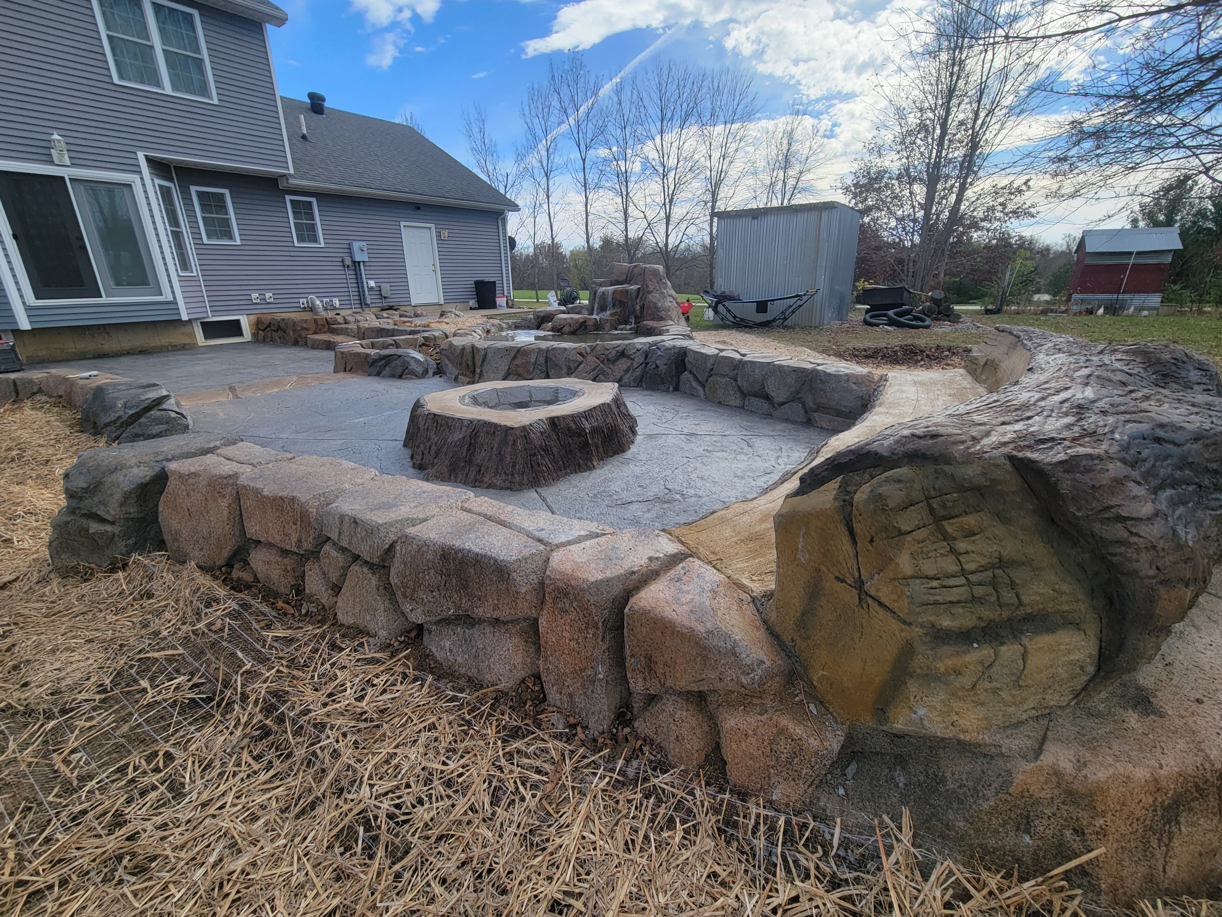 Water feature, fire pit, and patio