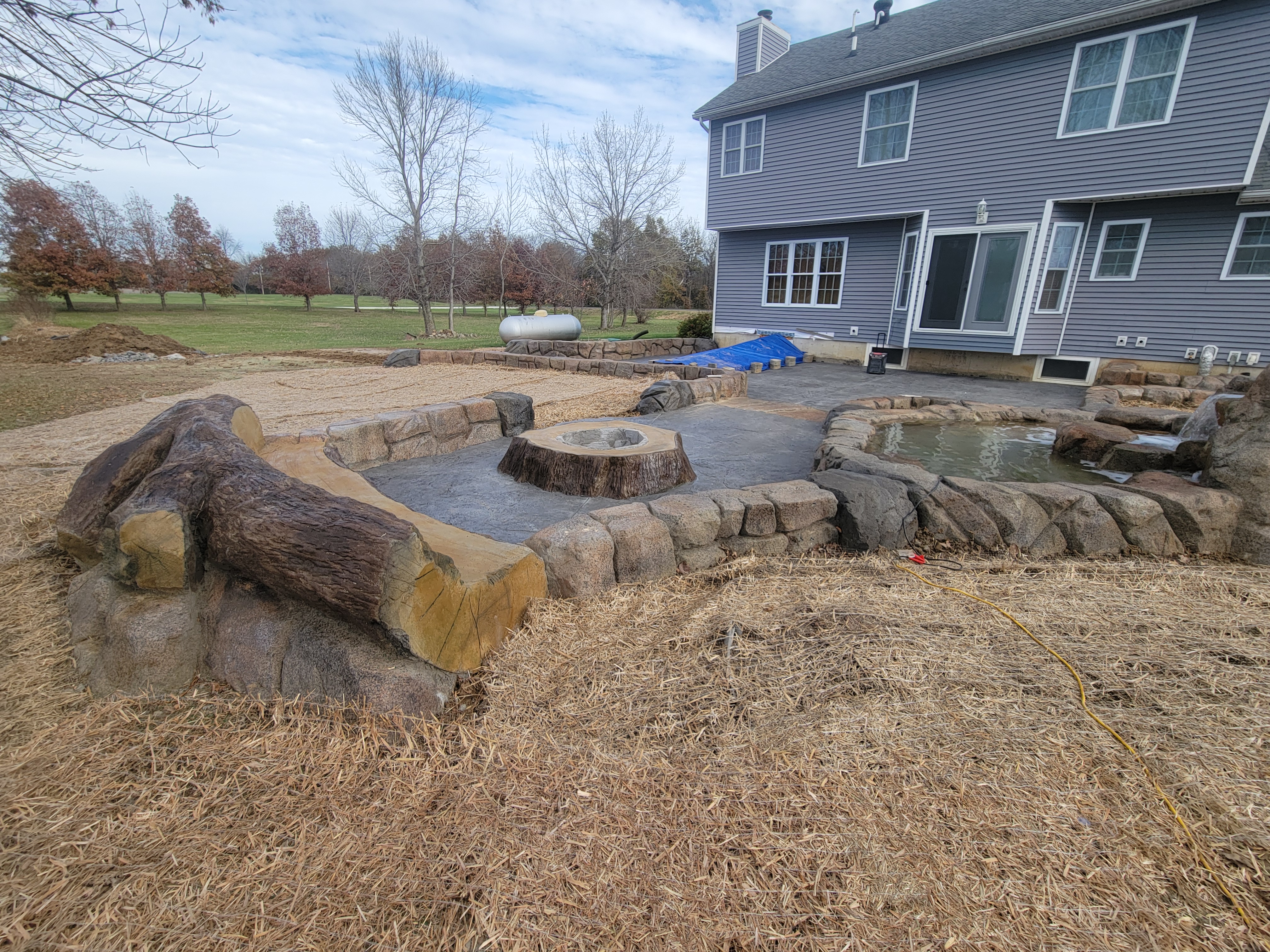 Water feature, fire pit, and patio